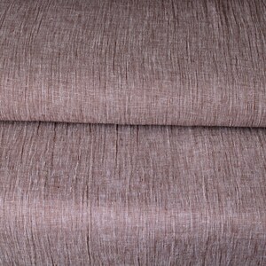 May include: Close-up of a brown fabric with a subtle woven texture. The fabric has a slightly rough, linen-like feel.
