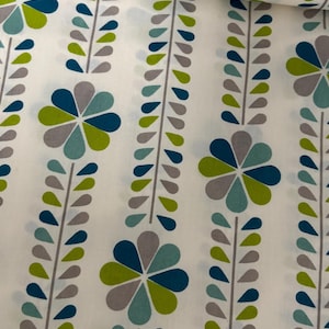 Puede incluir: Tela blanca con un estampado floral repetitivo. El diseño presenta flores estilizadas en verde azulado, gris y verde lima, con hojas a juego en forma de lágrima. Adecuado para diversos proyectos de costura.