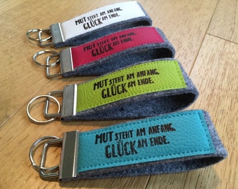 Felt keychain with imitation leather, lanyard, printed, stamp, text "Courage is at the beginning, luck at the end."