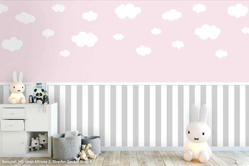May include: A pink and grey striped wallpaper with white clouds. The wallpaper is ideal for a nursery or child's room. The wallpaper is shown in a room with a white dresser and a white rabbit lamp.