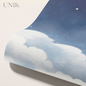 May include: A close-up of a blue and white watercolor painting of a night sky with clouds. The painting is rolled up and the edge of the paper is visible.