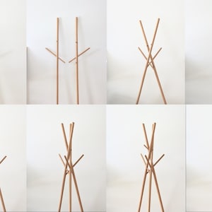 May include: A series of images showcasing a wooden coat rack. The rack has a tall, vertical pole with multiple horizontal arms for hanging clothes. The design is minimalist and modern, with a natural wood finish.