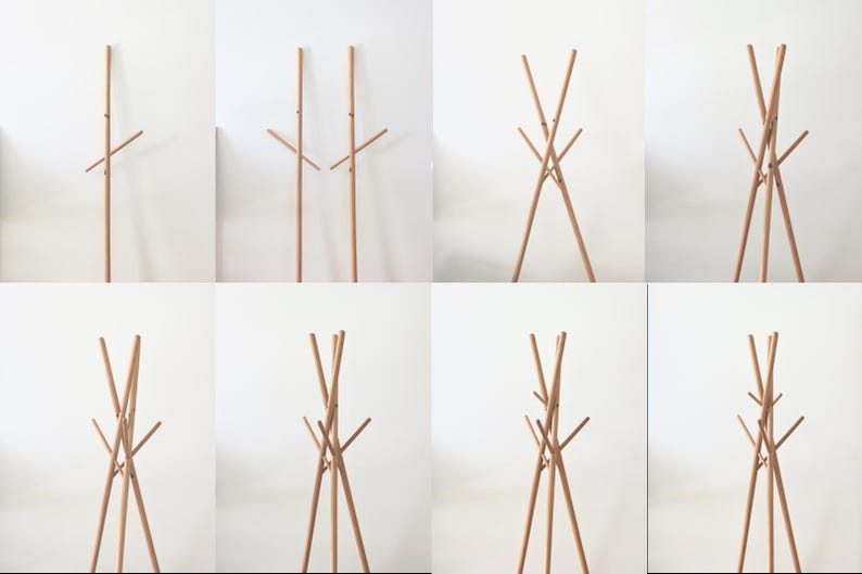 May include: A series of images showcasing a wooden coat rack. The rack has a tall, vertical pole with multiple horizontal arms for hanging clothes. The design is minimalist and modern, with a natural wood finish.