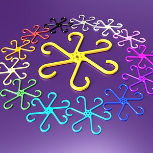 May include: A set of 12 colorful plastic hooks in various colors, including yellow, pink, blue, green, and purple. The hooks are shaped like a star with six points and have a small hole in the center.