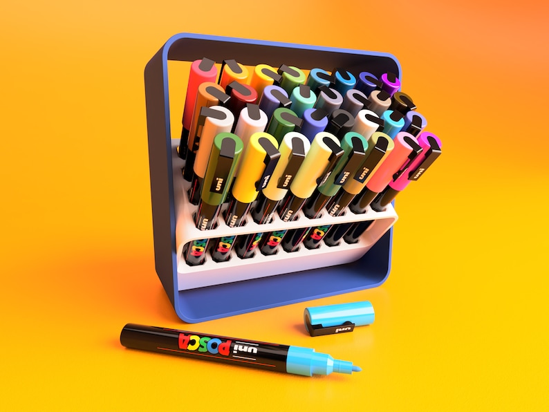 POSCA Paint marker holder case in white and blue. Case is shown in open position at 45 degree angle holding 32 POSCA PC-3M Paint markers.