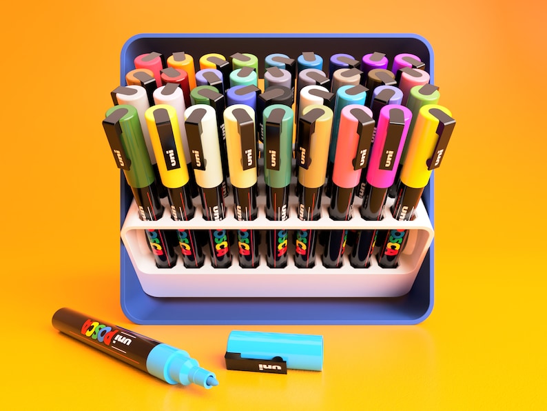 POSCA Paint marker holder case in white and blue. Case is shown in open position at 45 degree angle holding 36 POSCA PC-3M Paint markers.