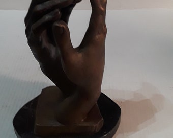 Hands on marble base bronze