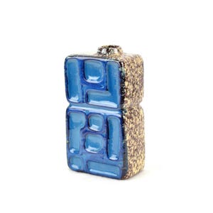 May include: A blue and brown ceramic vase with a geometric design. The vase is tall and rectangular.