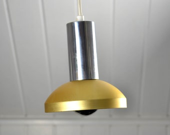 May include: A gold and chrome pendant light fixture with a round, gold-colored shade.