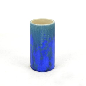 May include: A blue and green ceramic vase with a speckled glaze.