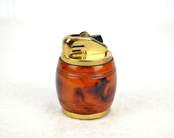 May include: A vintage gold-tone table lighter with a brown and black marbled plastic barrel.