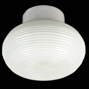 May include: White ceiling light fixture with a round, ribbed glass shade.
