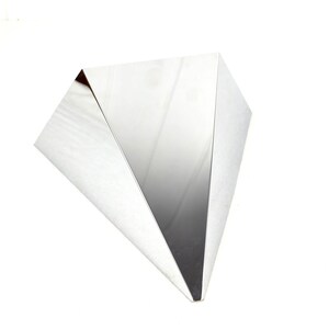 May include: A silver triangular shaped table with a reflective surface.