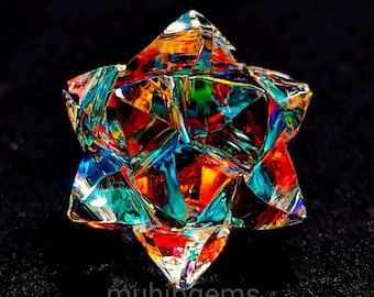 Puede incluir: Un objeto en forma de estrella multicolor y facetado, con una variedad de colores que incluyen rojo, azul, verde y naranja. El objeto está sobre un fondo negro. El texto "muhibgems" es visible en la parte inferior.