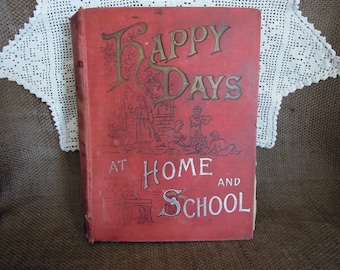 May include: Antique book titled "Happy Days at Home and School" with a red cover and gold lettering. The cover features illustrations of children and the title. The book is displayed on a brown surface with a white lace doily.