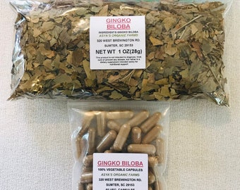 May include: Two clear plastic bags containing dried ginkgo biloba leaves and ginkgo biloba capsules. The bags are labeled with the name of the product, the ingredients, the address of the company, and the net weight. The product is sold by Asya's Organic Farms.