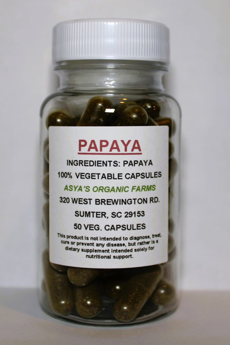May include: A clear glass bottle with a white lid filled with brown capsules. The label reads "PAPAYA", "INGREDIENTS: PAPAYA", "100% VEGETABLE CAPSULES", "ASYA'S ORGANIC FARMS", "320 WEST BREWINGTON RD.", "SUMTER, SC 29153", "50 VEG. CAPSULES". The label also includes a disclaimer that the product is not intended to diagnose, treat, cure or prevent any disease, but rather is a dietary supplement intended solely for nutritional support.