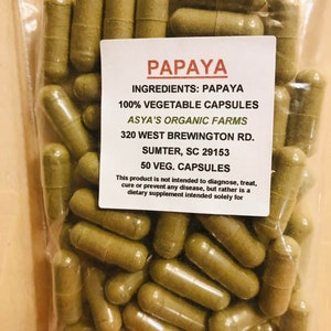 May include: A bag of 50 papaya vegetable capsules from Asya's Organic Farms. The bag is labeled with the ingredients, address, and contact information.  The capsules are a light green color.