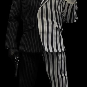 May include: A person in a black and white pinstripe suit, holding a gun and a coin. The figure's face is split, with one side normal and the other disfigured. The figure is wearing a red tie.