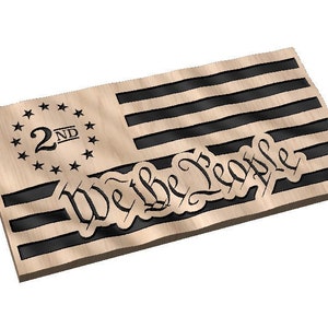 May include: A wooden American flag with black stripes and a circle of stars with the text "2ND" in the center. The words "We the People" are carved into the wood below the stripes.