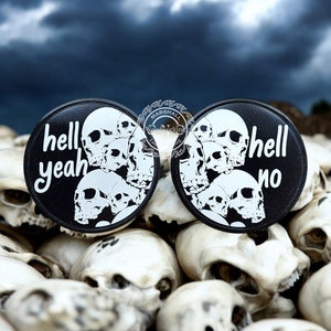 May include: Two black round buttons with white skull graphics and text. The left button says "hell yeah" and the right button says "hell no".