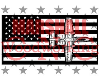 May include: Black and white silhouette of an A-10 Warthog airplane flying over an American flag. The flag is black and white with red text that says "MARSHALL WOODWORKING INC."