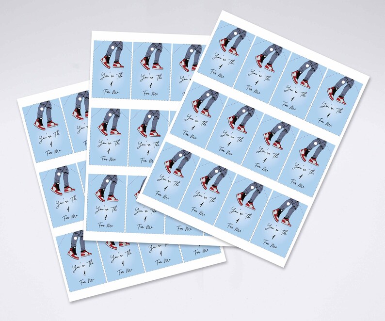 May include: Sheets of stickers with a pale blue background, featuring an illustration of legs in ripped jeans and red trainers. The text "You're the one for me" is printed on each sticker.