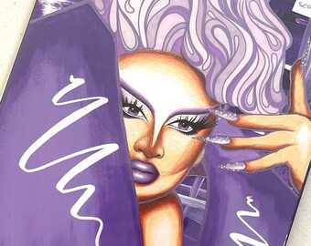 May include: Purple makeup palette with a portrait of a drag queen with a purple wig and a white swirl design. The text "VICTORIA SCONE 450" is on the palette.