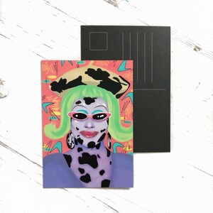 May include: A postcard featuring a colorful illustration of a person with green hair, wearing a black and white spotted outfit, pink sunglasses, and a black and white hat. The background is a pink and blue abstract design.