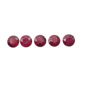 May include: Five round, red gemstones with a faceted cut.