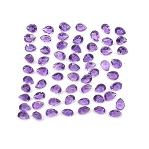 May include: A collection of amethyst pear-shaped gemstones, arranged in a grid pattern on a white background.