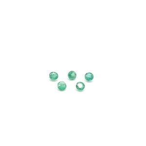 May include: Five round, green gemstones on a white background.