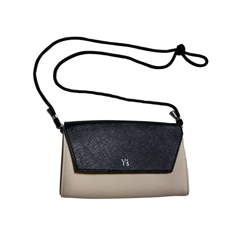 May include: A black and beige leather crossbody bag with a silver Y's logo.