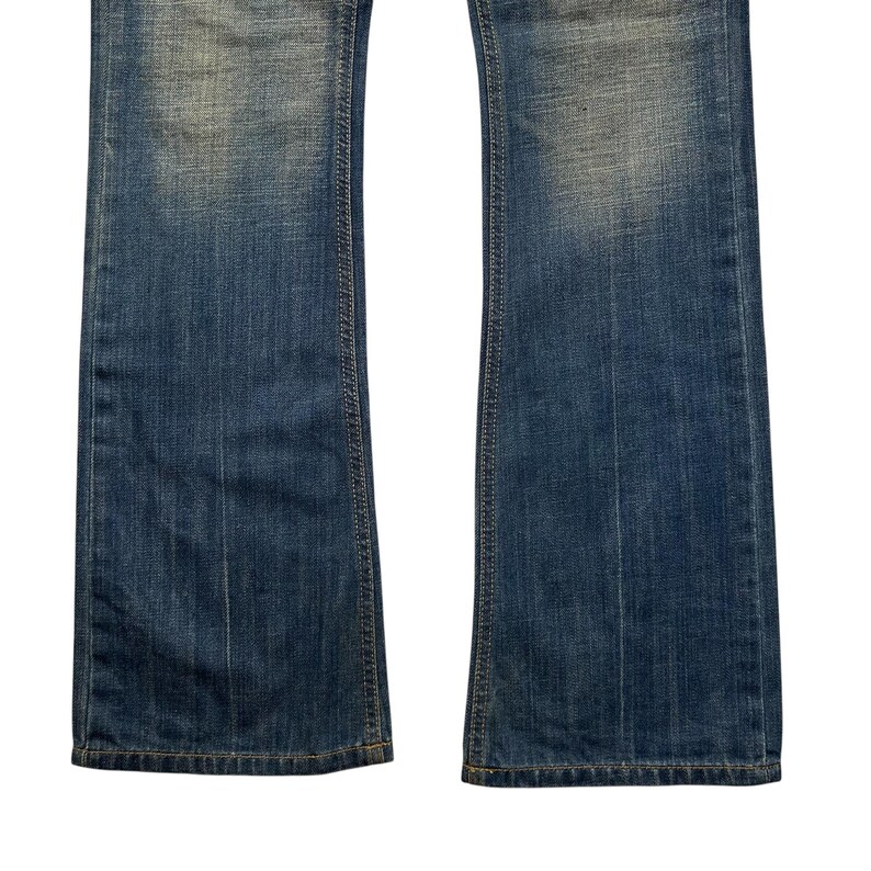 May include: Close-up of a pair of blue denim jeans. The jeans have a classic five-pocket design and a slight flare at the bottom. The denim has a faded wash with subtle variations in color.