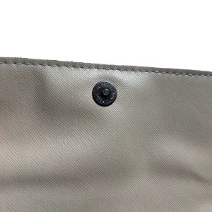 May include: Close-up of a light gray leather purse with a black metal snap closure.