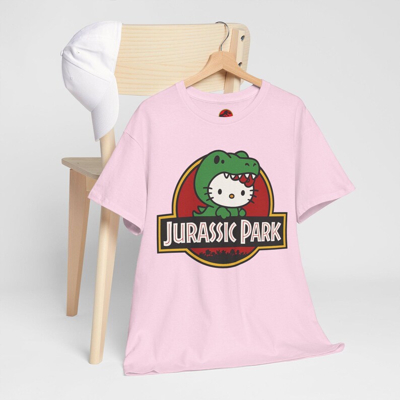 Hello Kitty Jurassic Park T-Shirt | Kawaii Dinosaur Mashup Tee | Cute Pink Graphic Shirt | Unisex Cotton Tee | Funny Movie Crossover Gift image 2