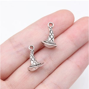 May include: Two silver witch hat charms with a textured design. The charms have a loop at the top for attaching to jewelry or other crafts.