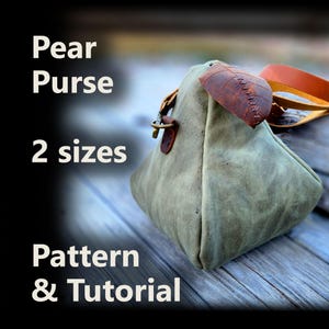May include: A pear-shaped purse in a muted green hue, featuring a brown leather accent and strap. The purse has a unique design with a leaf-shaped leather detail. Text on the image reads "Pear Purse 2 sizes Pattern & Tutorial."