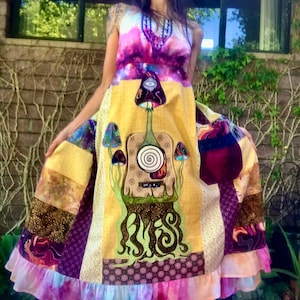 May include: A colorful patchwork dress with a psychedelic mushroom design. The dress has a ruffled hem and a tie-dye pattern.