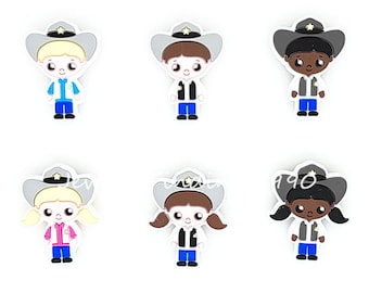 May include: Six colorful cowboy-themed charms. Each charm features a cartoon sheriff character with a gray hat, white shirt, blue pants, and a sheriff's badge. The characters have different skin tones and hair colors.
