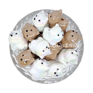 May include: A bowl of ceramic animal figurines. The figurines are in shades of brown and white with iridescent accents. The figurines are shaped like dogs.