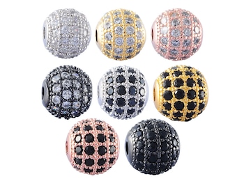 May include: Eight round beads with a grid pattern, each bead is covered in small rhinestones. The beads are in different colors: silver, gold, rose gold, black, and a combination of black and rose gold.