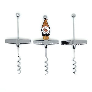 May include: Three silver wine bottle openers with a gnome design. The gnome is wearing a brown and orange hat and has a white beard. The gnome is holding a small brown object.