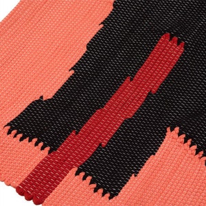 May include: A woven rug with a geometric pattern in shades of coral, red, and black. The rug has a textured surface and a fringed edge.