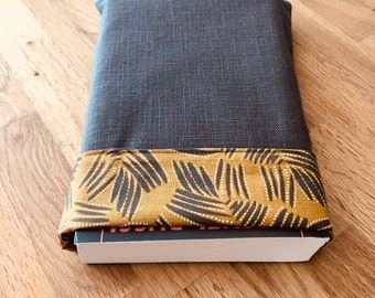 Pouch for large format paperback book in reversible charcoal gray and mustard yellow foliage print fabric