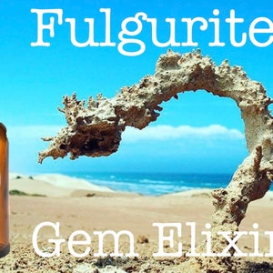 May include: A brown glass bottle with a dropper, labeled "Gem Elixir" and a brown paper label. The bottle is in front of a sandy beach with a large, light brown rock formation shaped like an archway. The text "Fulgurite" is written in white letters above the rock formation.