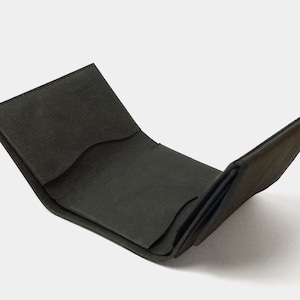 May include: A black leather wallet folded open, revealing the interior with multiple card slots and a billfold.