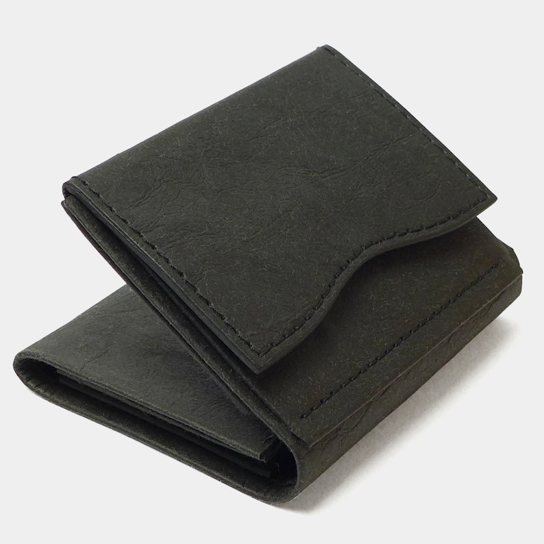 May include: A black leather trifold wallet with a textured surface and a flap closure.