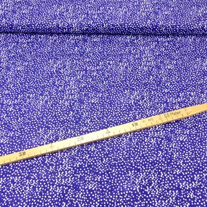 May include: Purple fabric with a white polka dot pattern. The fabric is measured with a ruler in inches.