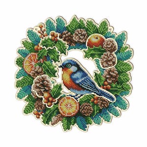 May include: A cross-stitch wreath featuring a blue and orange bird, surrounded by green leaves, pinecones, berries, and orange slices. The wreath has a light-colored wooden border and is designed for holiday or seasonal decor.
